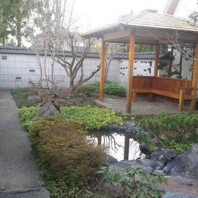 In the middle of the garden is a little pond with a stream, and a gazebo